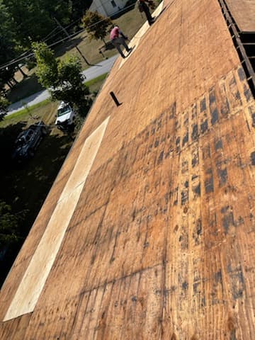 Exposed wood roof decking with a section of lighter plywood