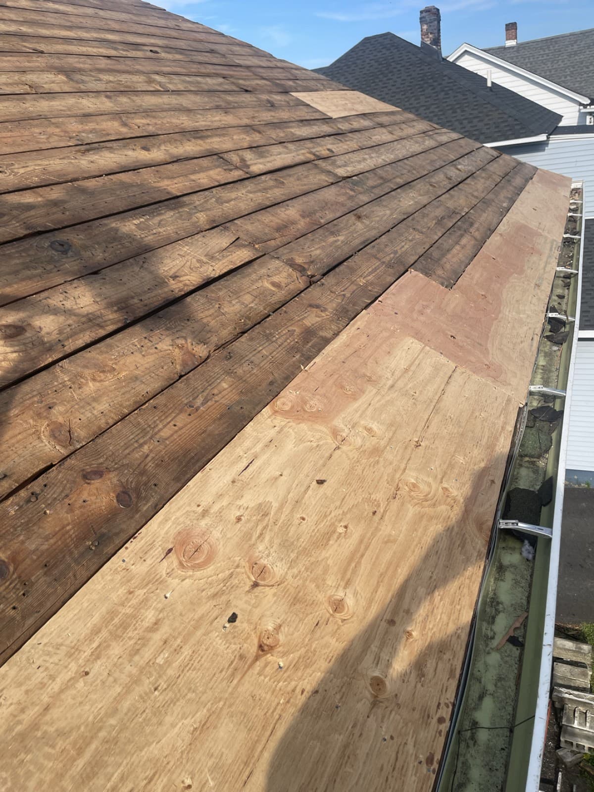 Roof stripped to wood boards with a plywood section along the edge