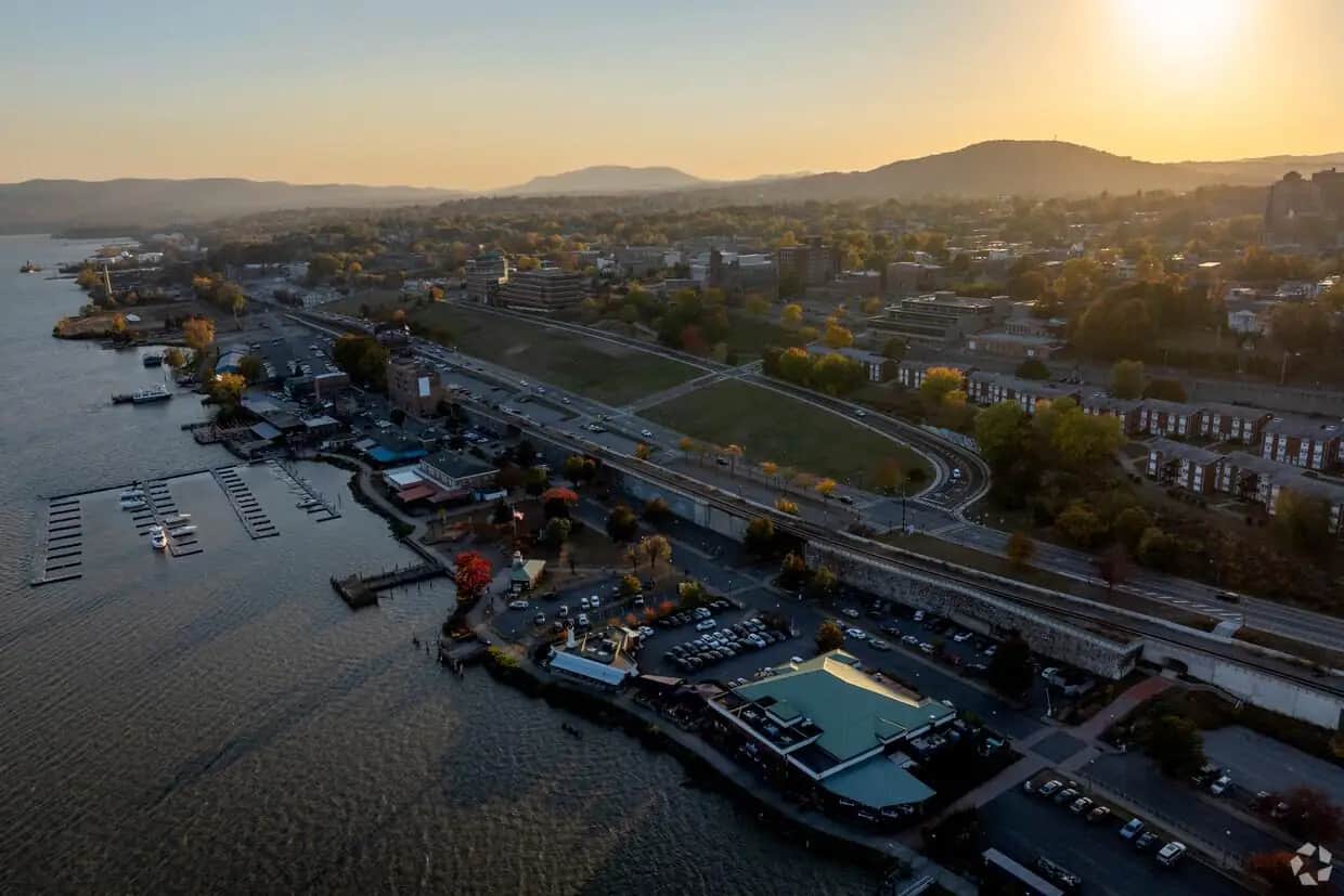 Aerial view of a Hudson River waterfront with boats and buildings at sunset