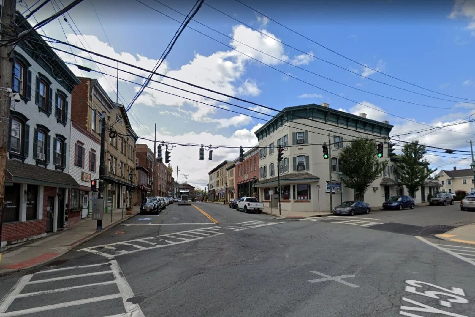 Street intersection with storefronts and overhead utility lines